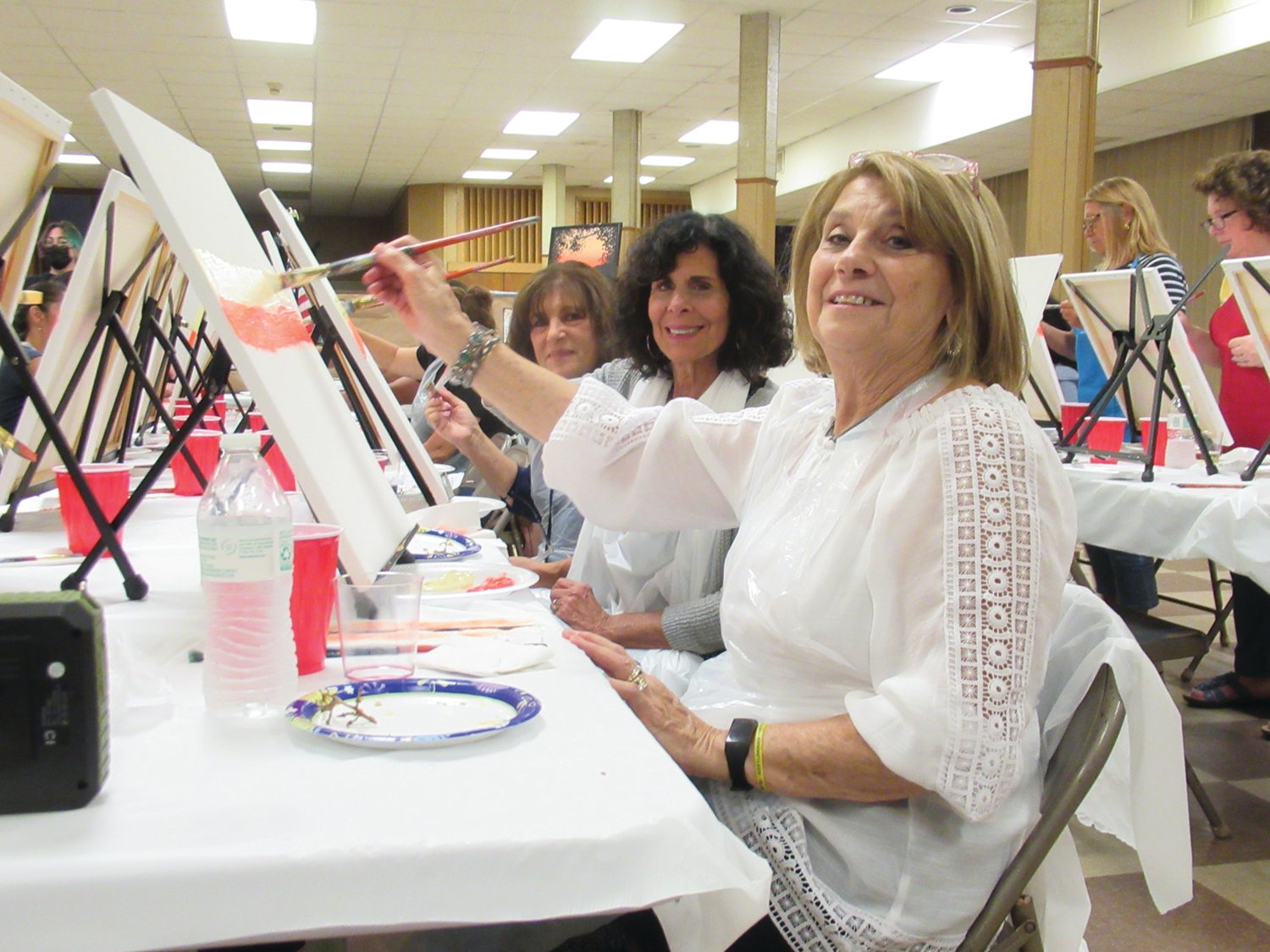 CANVAS CLUB: Cheryl Goneconte, Maria Mancini and Giovanna Venditelli show off their painting prowess while working a special sky and sunset scene during the Pannese Society’s recent fun-filled event inside OLG’s Fioretti Hall.